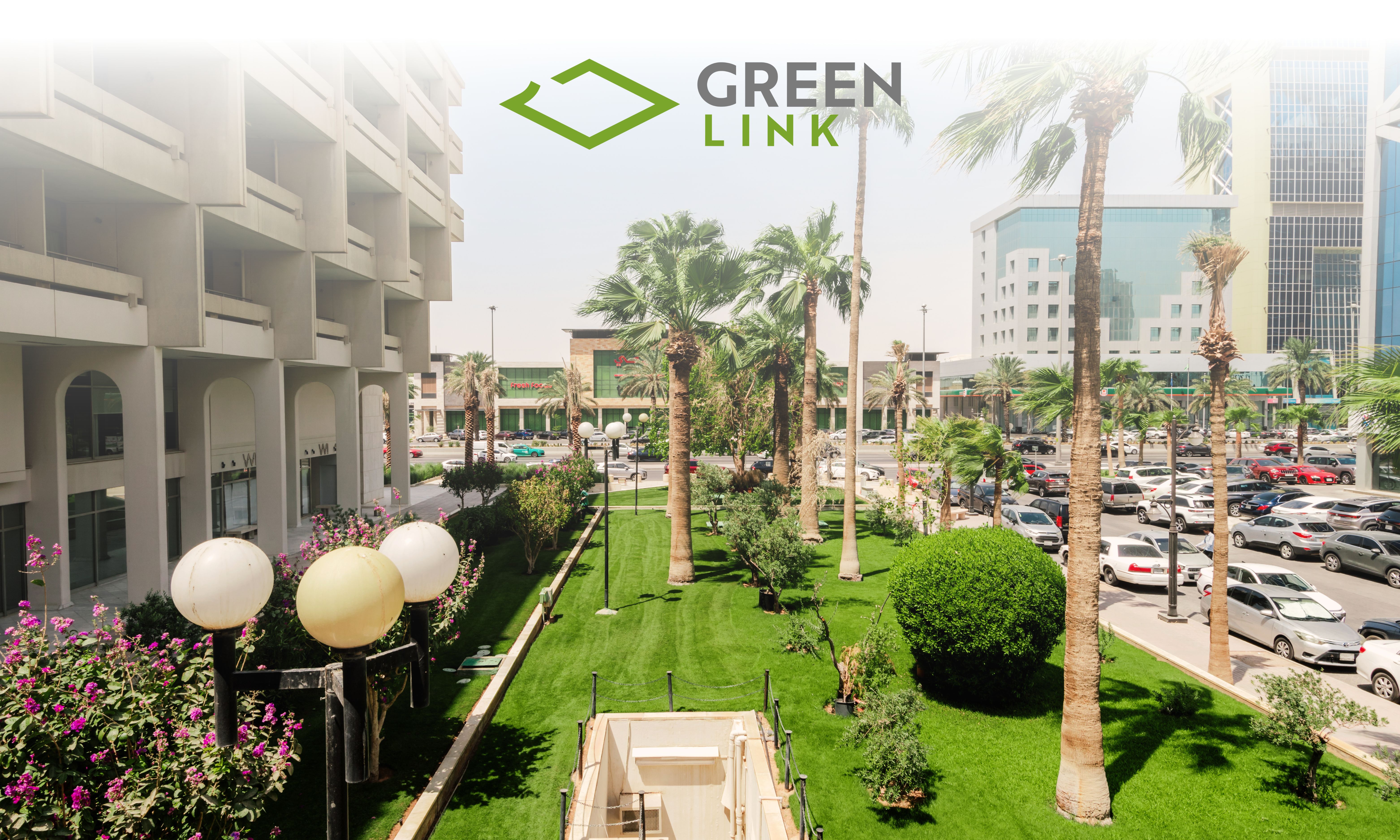 exterior_view_featuring_green_spaces_and_palm_trees_surrounded_by_modern_buildings